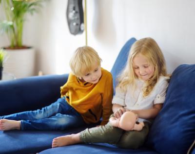 boy and girl looking at doll wondering proper names for their body parts