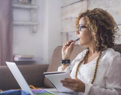 woman writing on a computer