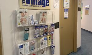 Brochure rack outside the interior door of The Village's Minot office