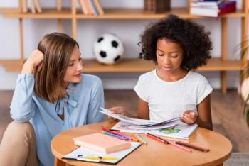 Child in EMDR therapy coloring with a therapist