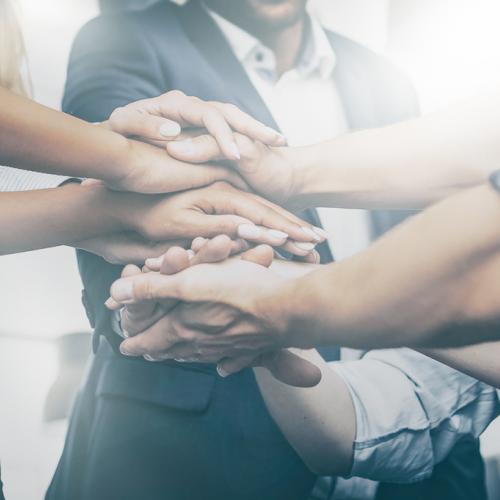 Group of people with their hands in a circle