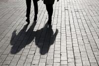 the shadows of two people walking together